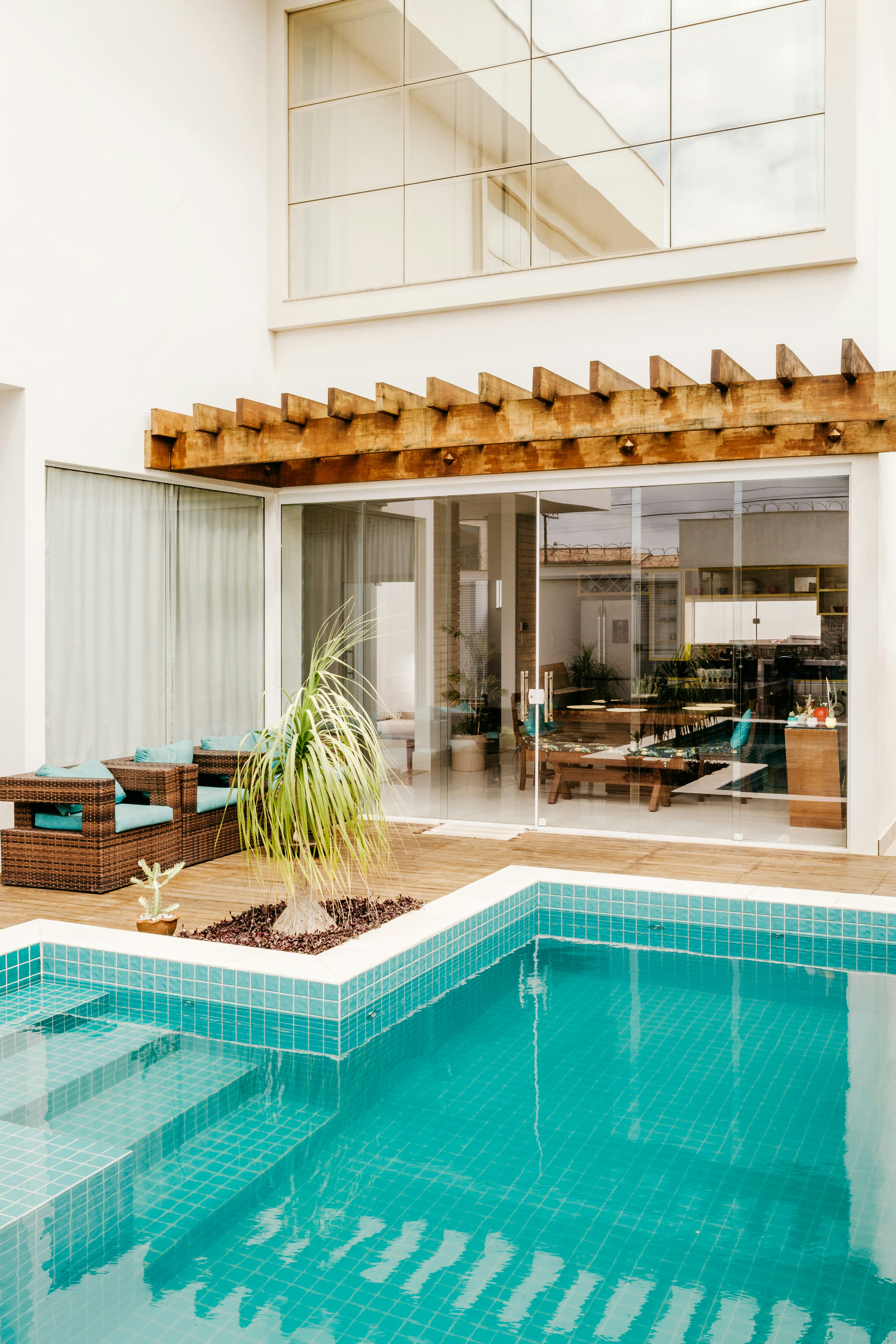 brown wooden chairs near swimming pool